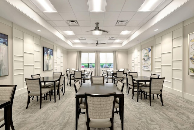 11051 SW Ivory Springs Ln, Port Saint Lucie, FL 34987 - dining area featuring a tray ceiling, light colored carpet, and a ceiling fan