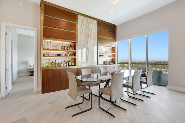 1 N Ocean Blvd Unit Ph05, Pompano Beach, FL 33062 - dining area featuring light wood-style flooring, a dry bar, and baseboards