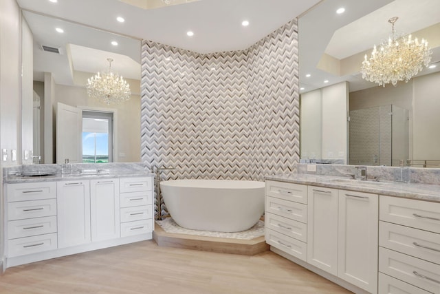 1 N Ocean Blvd Unit Ph05, Pompano Beach, FL 33062 - full bath featuring a chandelier, two vanities, a freestanding bath, tile walls, and recessed lighting