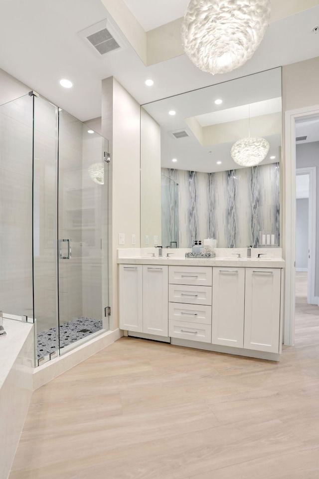 1 N Ocean Blvd Unit Ph05, Pompano Beach, FL 33062 - bathroom featuring double vanity, a stall shower, wood finished floors, recessed lighting, and a chandelier
