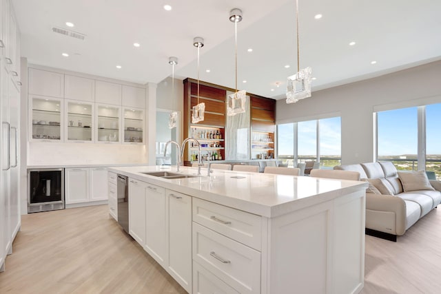 1 N Ocean Blvd Unit Ph05, Pompano Beach, FL 33062 - kitchen featuring a sink, beverage cooler, stainless steel dishwasher, a large island with sink, and glass insert cabinets