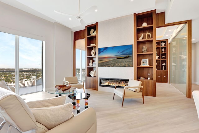 1 N Ocean Blvd Unit Ph05, Pompano Beach, FL 33062 - living area with ceiling fan, light wood finished floors, a fireplace, recessed lighting, and built in shelves