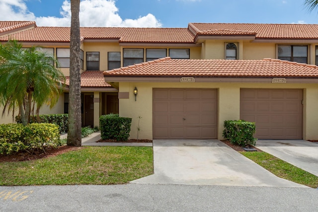 12236 Sag Harbor Ct Unit 3, Wellington, FL 33414 - view of property with a tiled roof, stucco siding, driveway, and a garage