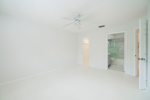 12236 Sag Harbor Ct Unit 3, Wellington, FL 33414 - unfurnished bedroom with a spacious closet, a closet, connected bathroom, baseboards, and ceiling fan