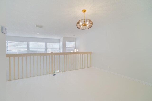 12236 Sag Harbor Ct Unit 3, Wellington, FL 33414 - empty room featuring a chandelier, plenty of natural light, and baseboards