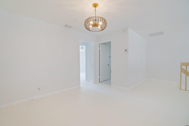 12236 Sag Harbor Ct Unit 3, Wellington, FL 33414 - spare room featuring a chandelier, baseboards, and light carpet