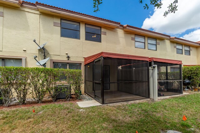 12236 Sag Harbor Ct Unit 3, Wellington, FL 33414 - back of house featuring a sunroom, stucco siding, and a tiled roof
