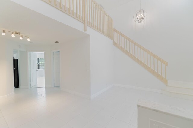 12236 Sag Harbor Ct Unit 3, Wellington, FL 33414 - stairs featuring a chandelier, tile patterned flooring, and baseboards