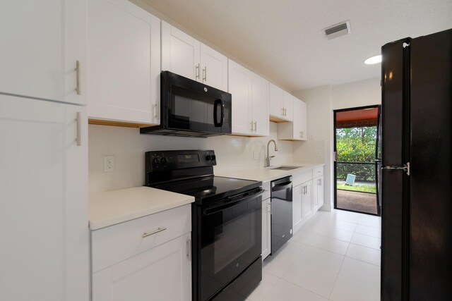 12236 Sag Harbor Ct Unit 3, Wellington, FL 33414 - kitchen with black appliances, a sink, light countertops, white cabinets, and light tile patterned flooring