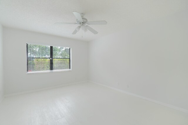 12236 Sag Harbor Ct Unit 3, Wellington, FL 33414 - spare room featuring baseboards and ceiling fan