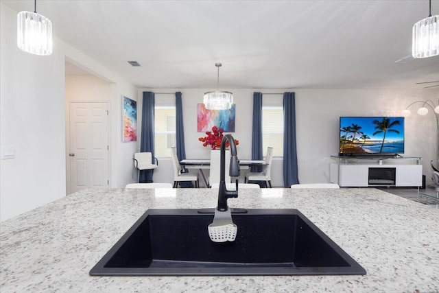12314 SW Rimini Way, Port Saint Lucie, FL 34987 - kitchen featuring a sink, plenty of natural light, open floor plan, and decorative light fixtures
