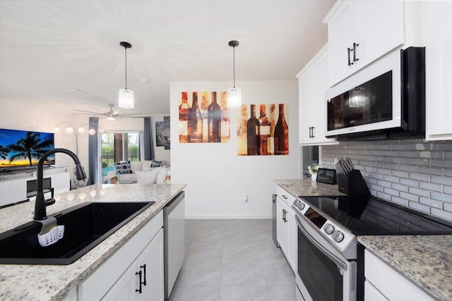 12314 SW Rimini Way, Port Saint Lucie, FL 34987 - kitchen featuring stainless steel appliances, a sink, decorative backsplash, ceiling fan, and white cabinetry