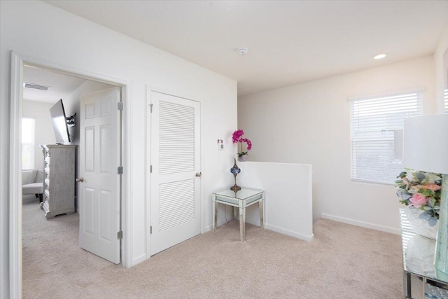 12314 SW Rimini Way, Port Saint Lucie, FL 34987 - hall featuring light colored carpet, plenty of natural light, and baseboards