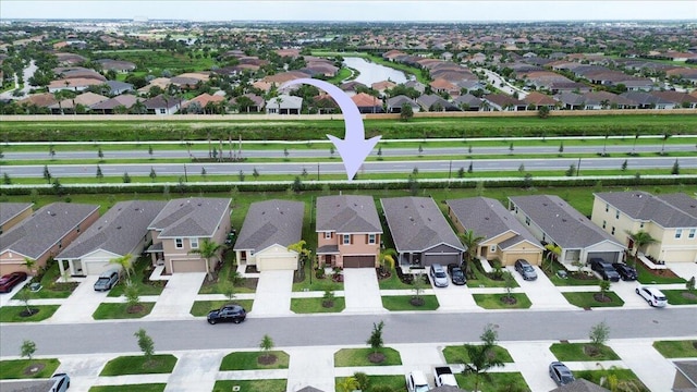 12314 SW Rimini Way, Port Saint Lucie, FL 34987 - aerial perspective of suburban area with a nearby body of water
