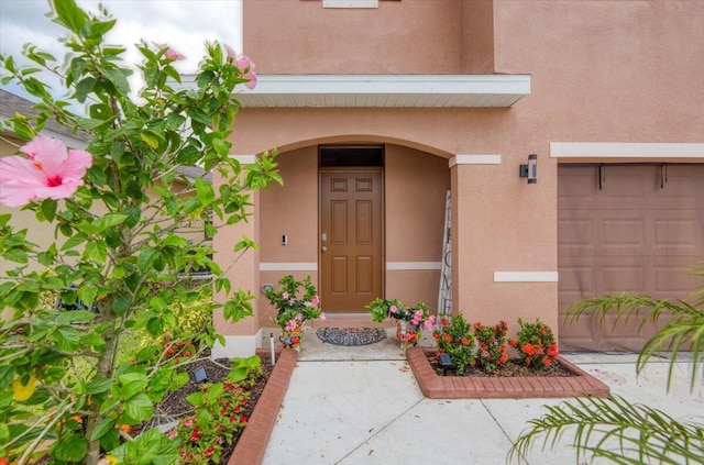 12314 SW Rimini Way, Port Saint Lucie, FL 34987 - entrance to property with stucco siding and an attached garage