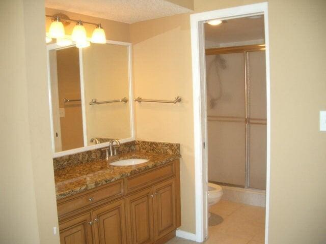 300 Ocean Trail Way Unit 1302, Jupiter, FL 33477 - full bath with toilet, a shower with door, vanity, and tile patterned floors