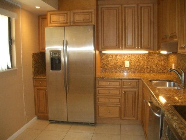 300 Ocean Trail Way Unit 1302, Jupiter, FL 33477 - kitchen featuring appliances with stainless steel finishes, a sink, decorative backsplash, and light tile patterned floors