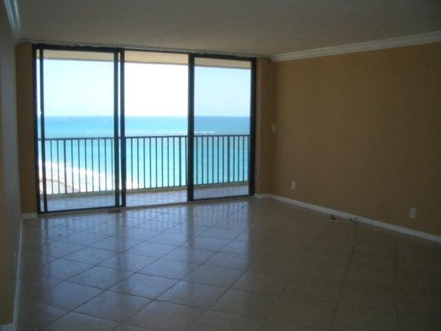 300 Ocean Trail Way Unit 1302, Jupiter, FL 33477 - tiled empty room with baseboards, crown molding, and a water view