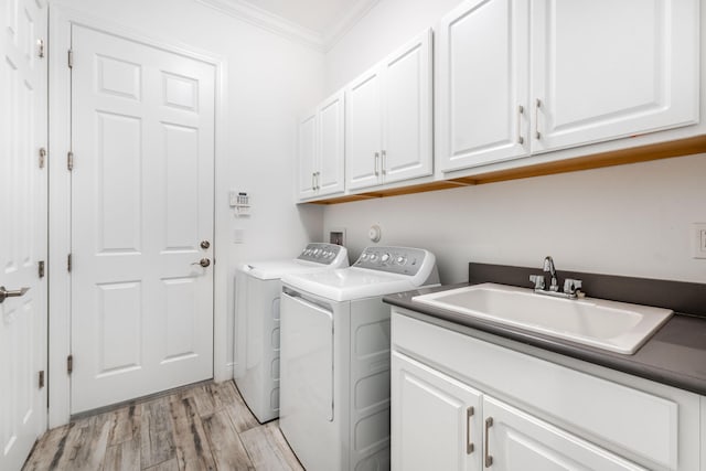 8762 SW Montova Way, Port Saint Lucie, FL 34987 - laundry room featuring cabinet space, washer and dryer, crown molding, and light wood-style flooring