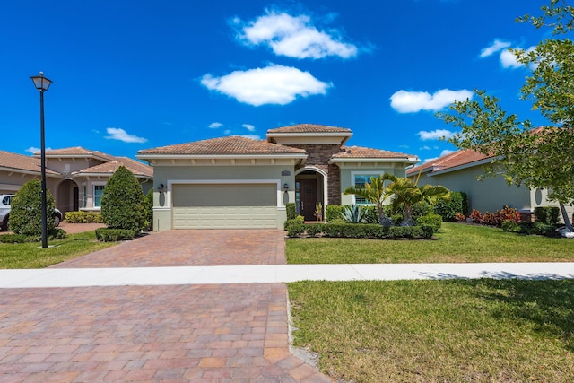 8762 SW Montova Way, Port Saint Lucie, FL 34987 - mediterranean / spanish home featuring a garage, a tiled roof, stucco siding, a front yard, and decorative driveway