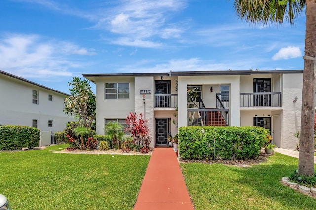 13194 Lucina Palm Ct Unit D, Delray Beach, FL 33484 - view of front of home with stucco siding and a front lawn