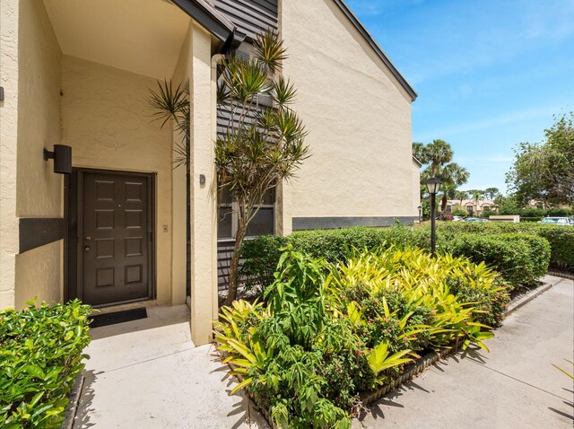 3961 SW Greenwood Way Unit D, Palm City, FL 34990 - property entrance featuring stucco siding