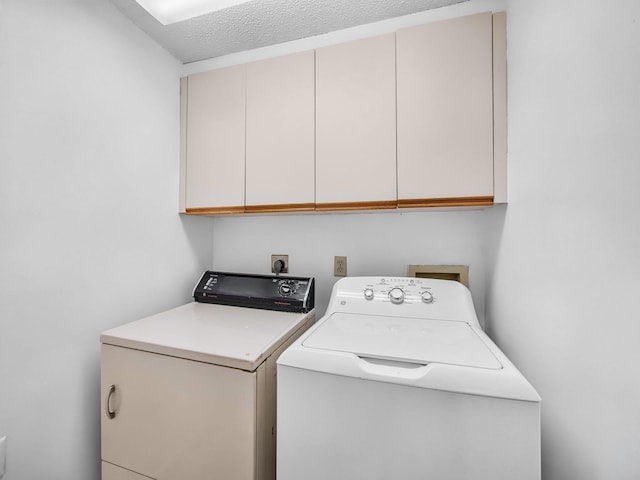 3961 SW Greenwood Way Unit D, Palm City, FL 34990 - laundry area featuring cabinet space, separate washer and dryer, and a textured ceiling