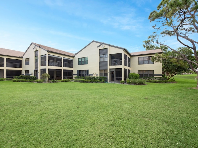 3961 SW Greenwood Way Unit D, Palm City, FL 34990 - rear view of house with a yard and stucco siding