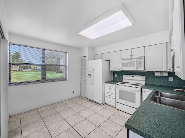 3961 SW Greenwood Way Unit D, Palm City, FL 34990 - kitchen with white appliances, a sink, dark countertops, and white cabinets
