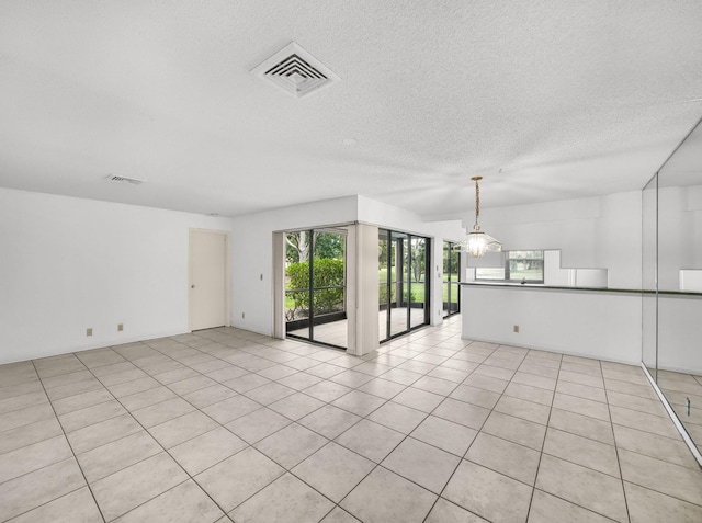 3961 SW Greenwood Way Unit D, Palm City, FL 34990 - unfurnished room featuring a textured ceiling and light tile patterned floors