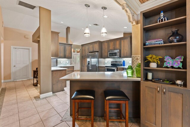 16673 75th Way N, Palm Beach Gardens, FL 33418 - kitchen with appliances with stainless steel finishes, backsplash, a peninsula, light tile patterned flooring, and vaulted ceiling