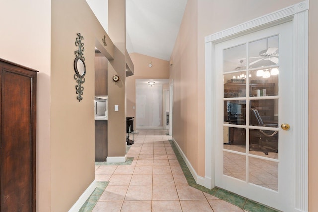 16673 75th Way N, Palm Beach Gardens, FL 33418 - hall featuring lofted ceiling, light tile patterned flooring, and baseboards