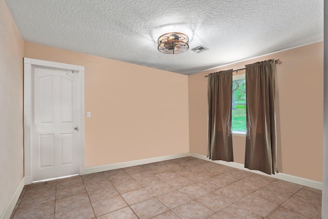 16673 75th Way N, Palm Beach Gardens, FL 33418 - spare room with a textured ceiling, light tile patterned floors, and baseboards