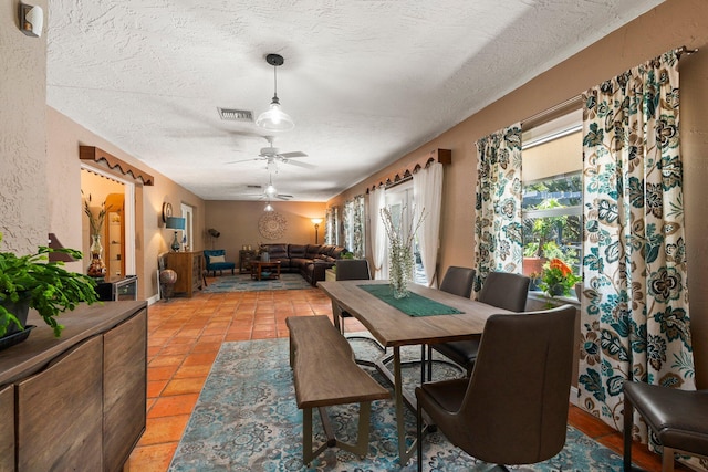 16673 75th Way N, Palm Beach Gardens, FL 33418 - dining area with a textured ceiling, ceiling fan, and light tile patterned flooring