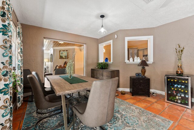 16673 75th Way N, Palm Beach Gardens, FL 33418 - dining room with a textured wall, baseboards, and a textured ceiling