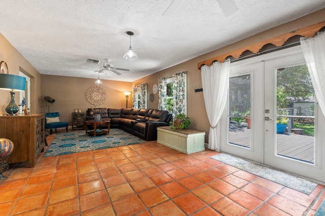 16673 75th Way N, Palm Beach Gardens, FL 33418 - living area featuring ceiling fan, a textured ceiling, and light tile patterned floors