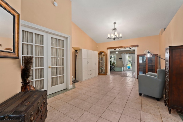 16673 75th Way N, Palm Beach Gardens, FL 33418 - entryway featuring a chandelier, light tile patterned floors, high vaulted ceiling, and french doors