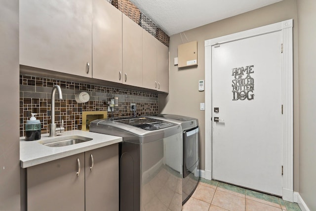 16673 75th Way N, Palm Beach Gardens, FL 33418 - laundry room featuring washer and dryer, cabinet space, light tile patterned flooring, and baseboards