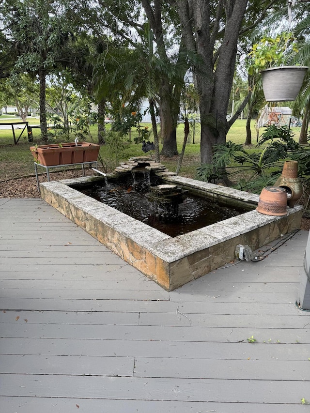 16673 75th Way N, Palm Beach Gardens, FL 33418 - wooden deck featuring a small pond
