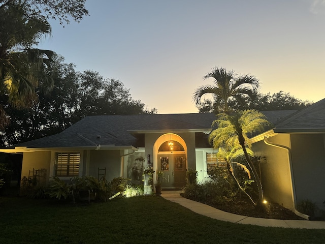 16673 75th Way N, Palm Beach Gardens, FL 33418 - view of front facade featuring stucco siding and a lawn