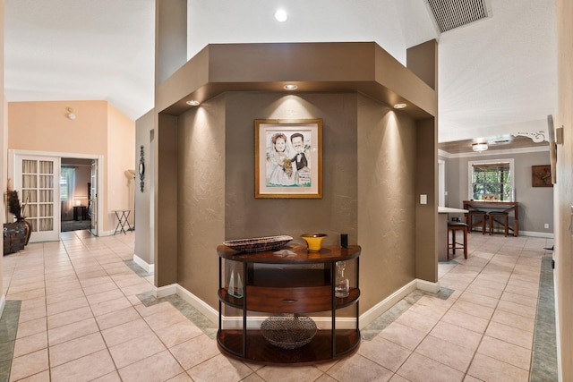 16673 75th Way N, Palm Beach Gardens, FL 33418 - corridor featuring light tile patterned floors, baseboards, lofted ceiling, and french doors