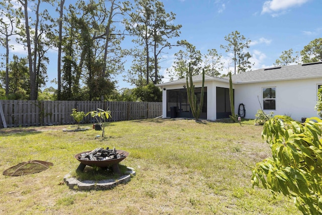 1649 Talbott St SE, Palm Bay, FL 32909 - view of yard with an outdoor fire pit and a sunroom