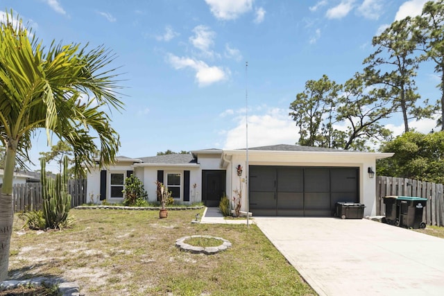 1649 Talbott St SE, Palm Bay, FL 32909 - ranch-style home featuring stucco siding, an attached garage, and driveway