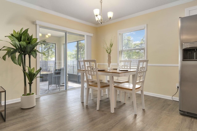 1649 Talbott St SE, Palm Bay, FL 32909 - dining area featuring plenty of natural light, a chandelier, wood finished floors, ornamental molding, and baseboards