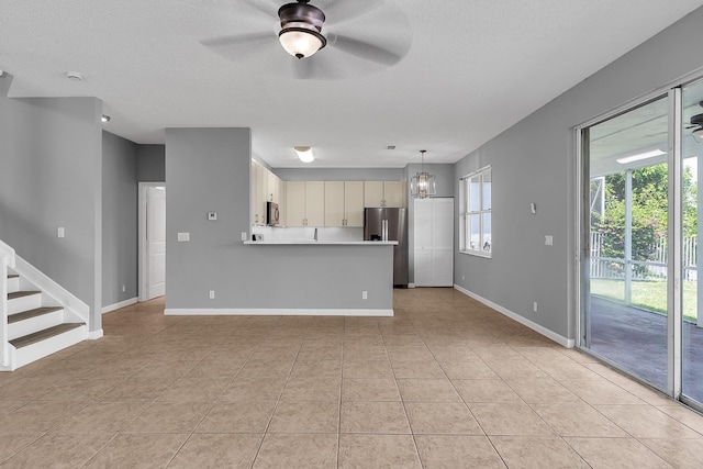 123 Canterbury Pl, Royal Palm Beach, FL 33414 - kitchen featuring appliances with stainless steel finishes, light countertops, light tile patterned flooring, ceiling fan, and a peninsula