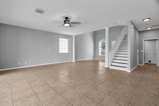 123 Canterbury Pl, Royal Palm Beach, FL 33414 - unfurnished living room with tile patterned flooring, ceiling fan, stairs, a textured ceiling, and baseboards
