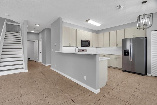 123 Canterbury Pl, Royal Palm Beach, FL 33414 - kitchen featuring appliances with stainless steel finishes, light tile patterned floors, light countertops, a peninsula, and recessed lighting