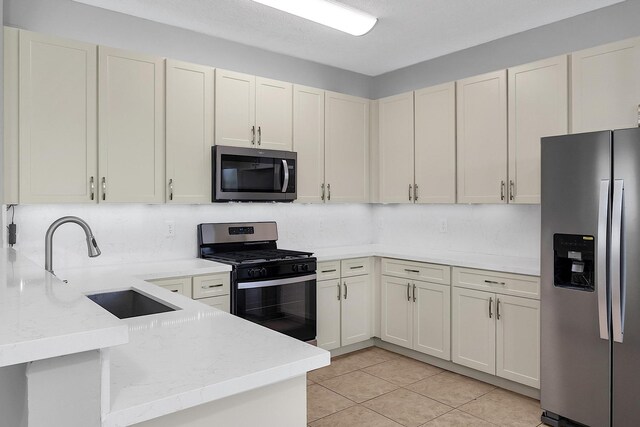123 Canterbury Pl, Royal Palm Beach, FL 33414 - kitchen featuring stainless steel appliances, a sink, a peninsula, light stone countertops, and light tile patterned flooring