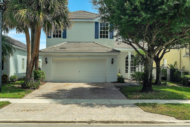 123 Canterbury Pl, Royal Palm Beach, FL 33414 - view of front of property featuring decorative driveway, central air condition unit, a tiled roof, and stucco siding