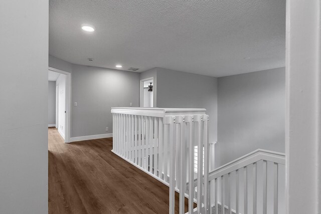 123 Canterbury Pl, Royal Palm Beach, FL 33414 - hallway with an upstairs landing, a textured ceiling, wood finished floors, recessed lighting, and baseboards